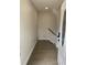 Bright entryway featuring wood-look flooring and access to the staircase with black railing at 1888 Peeler Rd, Dunwoody, GA 30338