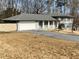 Split-level home featuring an attached garage and covered front porch at 1888 Peeler Rd, Dunwoody, GA 30338