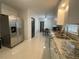 Kitchen featuring stainless steel appliances, white cabinets, and tiled floors at 1888 Peeler Rd, Dunwoody, GA 30338
