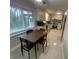 Cozy kitchen featuring white cabinets, stainless steel appliances, and a dining table at 1888 Peeler Rd, Dunwoody, GA 30338