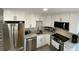 Stylish kitchen featuring white cabinets, granite countertops, and stainless steel appliances at 1888 Peeler Rd, Dunwoody, GA 30338