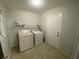 Laundry room featuring tiled floors, washer, and dryer at 1888 Peeler Rd, Dunwoody, GA 30338