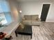 Cozy living room featuring a tan sofa, coffee table, and natural light from the window at 1888 Peeler Rd, Dunwoody, GA 30338