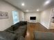 Living room featuring hardwood floors, neutral walls, and a large gray sofa at 1888 Peeler Rd, Dunwoody, GA 30338