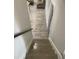 Staircase featuring grey wood-look floors leading to the living area with tan sofa and coffee table at 1888 Peeler Rd, Dunwoody, GA 30338