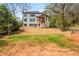 Expansive backyard featuring a white house, wooden deck, and lush green grass at 5915 Brookgreen Rd, Atlanta, GA 30328