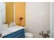Stylish powder room with a designer sink, decorative mirror, and patterned wallpaper at 5915 Brookgreen Rd, Atlanta, GA 30328