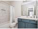 Bathroom with blue vanity, white countertop and tiled shower and bathtub at 5915 Brookgreen Rd, Atlanta, GA 30328