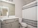 Neutral toned bathroom featuring a grey vanity, white countertop, and patterned shower curtain at 5915 Brookgreen Rd, Atlanta, GA 30328
