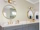 Modern bathroom featuring a double vanity with marble countertop, gold fixtures and decorative mirrors at 5915 Brookgreen Rd, Atlanta, GA 30328