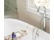 Close-up of a bathtub with a modern faucet and convenient storage tray at 5915 Brookgreen Rd, Atlanta, GA 30328