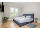 Serene bedroom with a platform bed, natural light, and hardwood floors at 5915 Brookgreen Rd, Atlanta, GA 30328