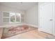 Bright bedroom with hardwood floors, a large area rug, and a window with white shutters at 5915 Brookgreen Rd, Atlanta, GA 30328