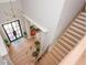 Modern foyer with hardwood floors, a contemporary light fixture, and a staircase with wooden steps at 5915 Brookgreen Rd, Atlanta, GA 30328