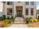 Inviting front entrance with elegant glass door, stone steps, and manicured landscaping enhancing curb appeal at 5915 Brookgreen Rd, Atlanta, GA 30328