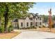 Beautiful brick home with an attached garage and a long driveway, surrounded by mature trees and landscaping at 5915 Brookgreen Rd, Atlanta, GA 30328