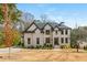 Stunning two-story brick home with manicured lawn and lush landscaping providing beautiful curb appeal at 5915 Brookgreen Rd, Atlanta, GA 30328