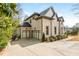 Spacious three-car garage with a paved driveway, complemented by the home's brick exterior and landscaping at 5915 Brookgreen Rd, Atlanta, GA 30328