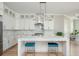 Modern kitchen with white cabinets, marble backsplash, and a large center island with seating at 5915 Brookgreen Rd, Atlanta, GA 30328