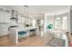 Spacious open kitchen with modern appliances, marble countertops, and adjacent seating area at 5915 Brookgreen Rd, Atlanta, GA 30328