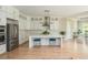 Modern kitchen features white cabinets, stainless steel appliances, and a marble countertop island at 5915 Brookgreen Rd, Atlanta, GA 30328
