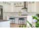 Bright kitchen with white cabinets, marble countertops, and modern stainless steel appliances at 5915 Brookgreen Rd, Atlanta, GA 30328