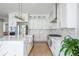 Bright kitchen with stainless steel appliances, marble countertops, and white cabinetry at 5915 Brookgreen Rd, Atlanta, GA 30328
