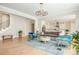 Bright living room features a modern chandelier, hardwood floors, and elegant furnishings at 5915 Brookgreen Rd, Atlanta, GA 30328