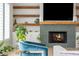 Cozy living room with a fireplace, floating shelves, and stylish blue chair at 5915 Brookgreen Rd, Atlanta, GA 30328