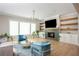 Cozy living room featuring a tiled fireplace, built-in shelves, and comfortable seating at 5915 Brookgreen Rd, Atlanta, GA 30328