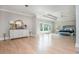 Bright main bedroom boasting hardwood floors, tray ceilings, large windows, and a decorative dresser at 5915 Brookgreen Rd, Atlanta, GA 30328