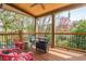 Covered porch with outdoor seating and views of the backyard at 5915 Brookgreen Rd, Atlanta, GA 30328