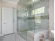 Large walk-in shower featuring marble tiles, a glass enclosure and a built-in bench for added comfort at 5915 Brookgreen Rd, Atlanta, GA 30328