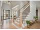 Elegant staircase featuring hardwood steps, iron railings, and natural light flowing through the open foyer area at 5915 Brookgreen Rd, Atlanta, GA 30328