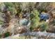 Birds eye view shows home sitting on a heavily wooded lot with mature trees at 1025 Pace Rd, Hiram, GA 30141