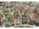 Aerial view showing a quiet neighborhood surrounded by lush trees and foliage at 1025 Pace Rd, Hiram, GA 30141