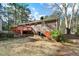 Exterior shot of brick home showing deck and stairs leading to the backyard at 1025 Pace Rd, Hiram, GA 30141