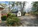 Private backyard features a storage shed and mature greenery and landscaping at 1025 Pace Rd, Hiram, GA 30141