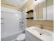 A bright bathroom featuring a shower-tub combo with white tile surround and modern sink at 1025 Pace Rd, Hiram, GA 30141