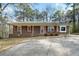 Charming brick home featuring a well-maintained front yard and concrete driveway at 1025 Pace Rd, Hiram, GA 30141