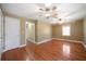 Spacious main bedroom with hardwood floors, two ceiling fans, and a window for natural light at 1025 Pace Rd, Hiram, GA 30141