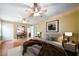 Stylishly furnished main bedroom boasting hardwood floors, ceiling fans and tasteful decor at 1025 Pace Rd, Hiram, GA 30141