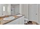 Bathroom featuring a double vanity, a light countertop, and a closed toilet area at 1054 Mackets Ct, Atlanta, GA 30354
