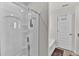This bathroom features a glass door shower, a white door, and a bathtub at 1054 Mackets Ct, Atlanta, GA 30354