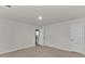 A light filled carpeted bedroom features an ensuite bathroom and door at 1054 Mackets Ct, Atlanta, GA 30354