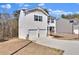 Two-story home with a two-car garage, black shutters, and low-maintenance landscaping at 1054 Mackets Ct, Atlanta, GA 30354