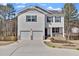 Charming two-story home with a two-car garage, black shutters, and a cozy front porch at 1054 Mackets Ct, Atlanta, GA 30354