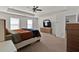 Spacious bedroom with carpet flooring, ceiling fan, and an ensuite bathroom at 1054 Mackets Ct, Atlanta, GA 30354