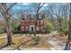 A picturesque brick house featuring a lush front yard with mature trees and landscaping at 1305 Fairview Ne Rd, Atlanta, GA 30306