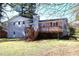 The backyard of this charming home features a new deck with stairs that lead down to the lawn at 2110 E Cherokee Dr, Woodstock, GA 30188